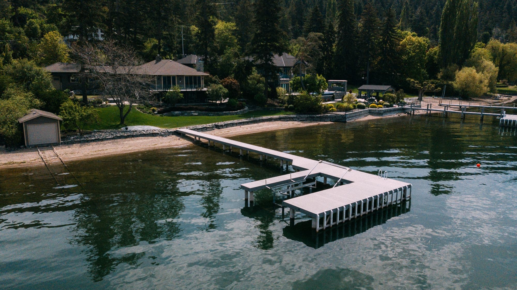 Custom residential dock in Vernon, BC featuring boat lifts, swim ladder, and spacious layout, designed for easy lake access and enhanced Okanagan living.