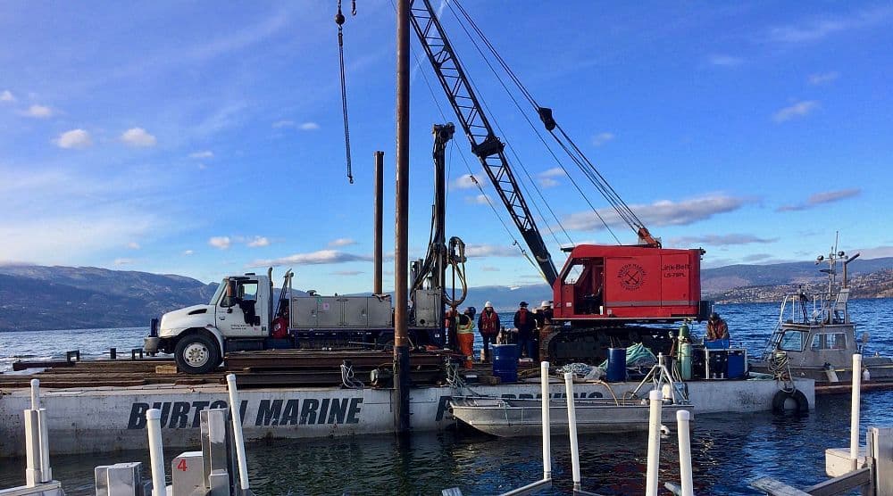 Wide view of drilling operations from Burton Marine’s custom barge on Okanagan Lake, BC, with test holes bored for marina engineering assessments.