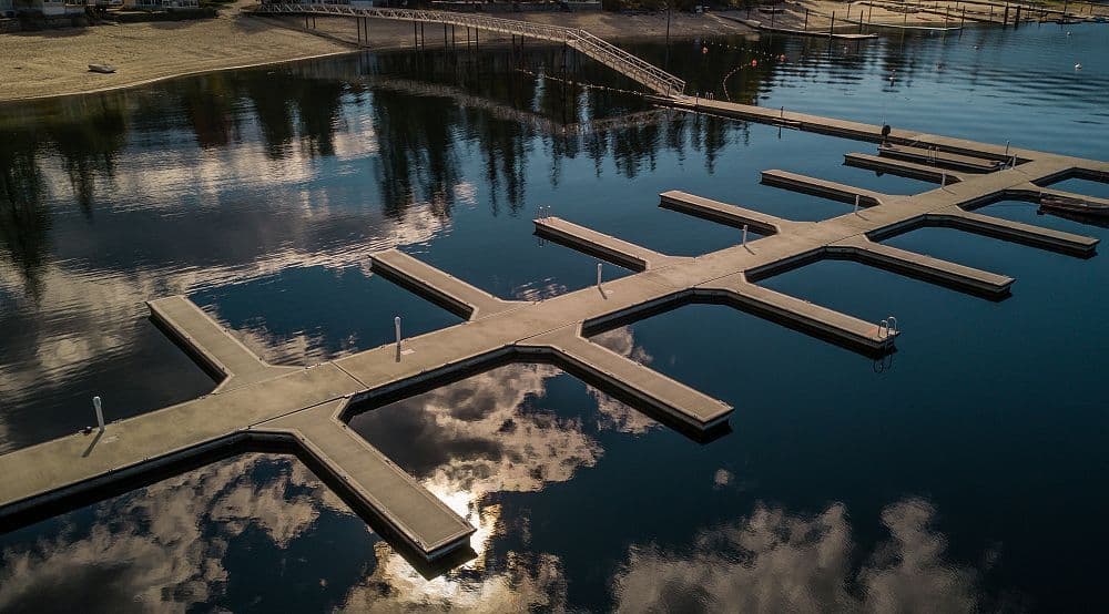 Overhead perspective of newly installed floating concrete marina slips at Mara Lake, BC, highlighting layout and watercraft capacity.