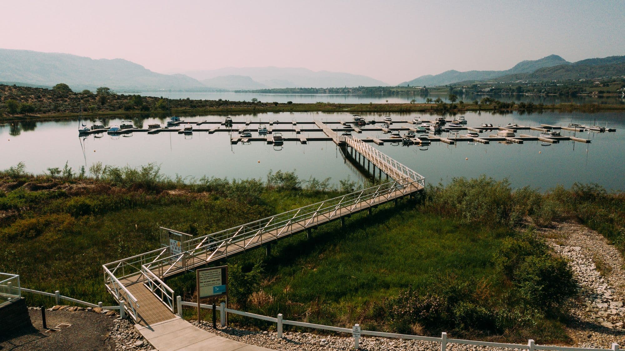 Accessible gangway bridge connecting shoreline to Osoyoos Cottages Marina, designed for safe entry to the dock system serving local residents.