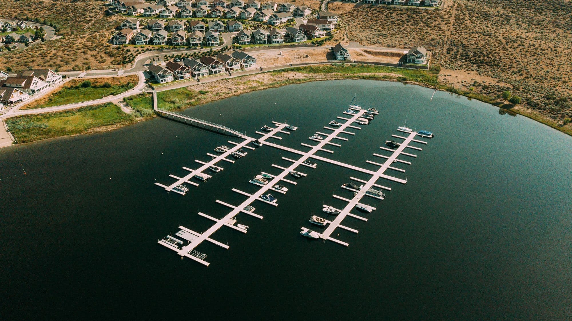 Drone capture of full Osoyoos Cottages Marina complex with surrounding residential area and waterfront development.