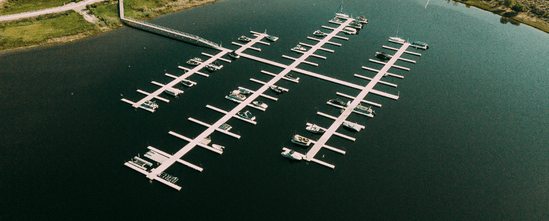 Aerial view of a completed marina in Osoyoos, BC, featuring modern dock systems and moored boats—part of Burton Marine's commercial waterfront infrastructure services.