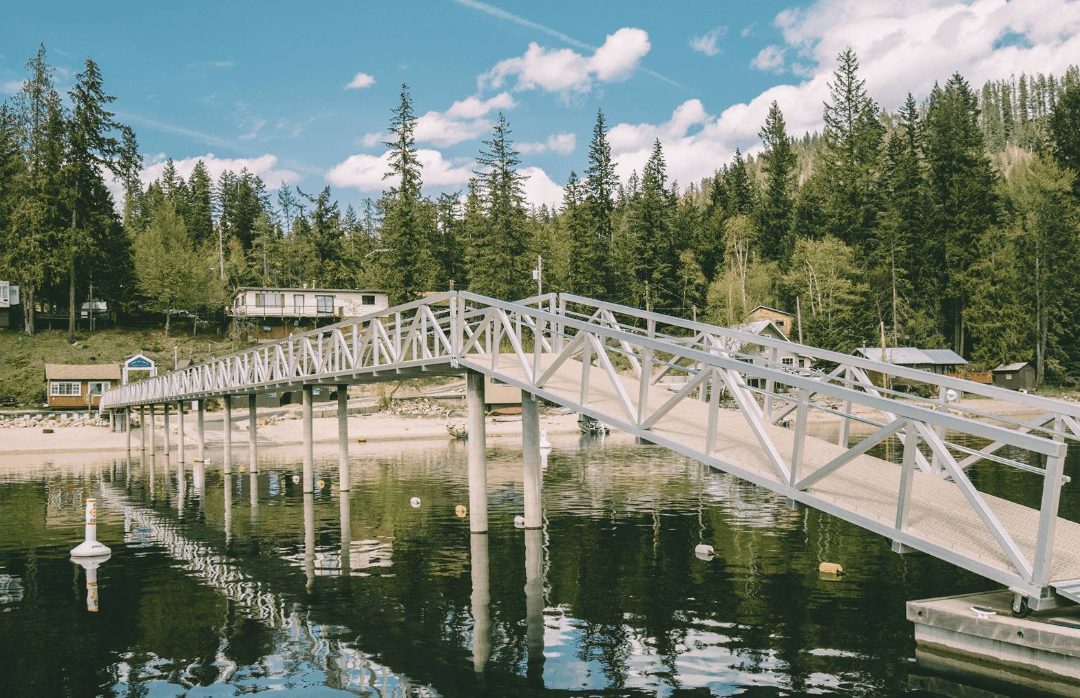 Aluminum gangway dock system installed over lakefront by Burton Marine Pile Driving, featuring deep-water pilings and precision marine construction
