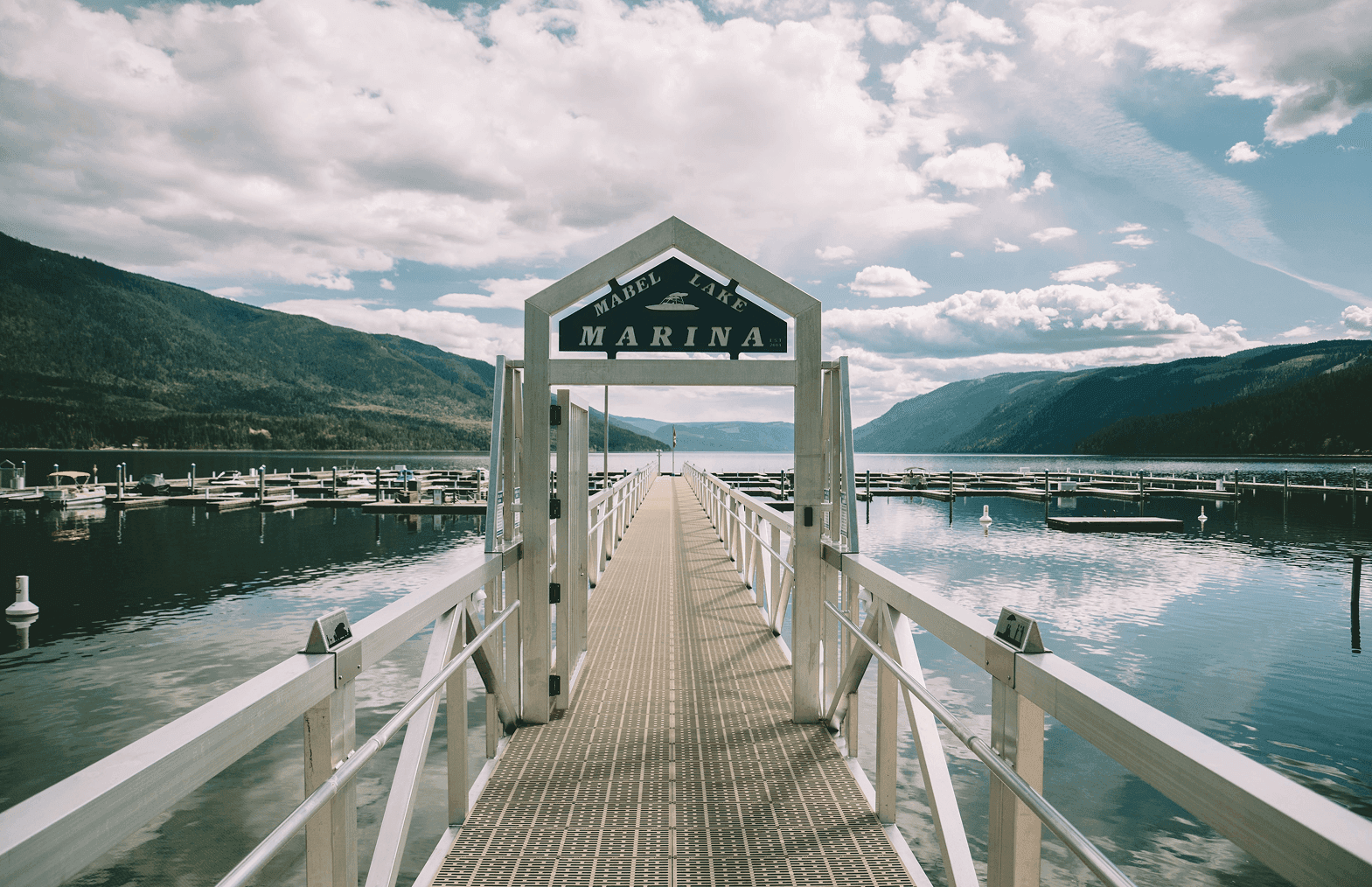 Architectural view of the entrance gangway to Mabel Lake Marina, BC, designed by Burton Marine for smooth public access to the floating marina system.
