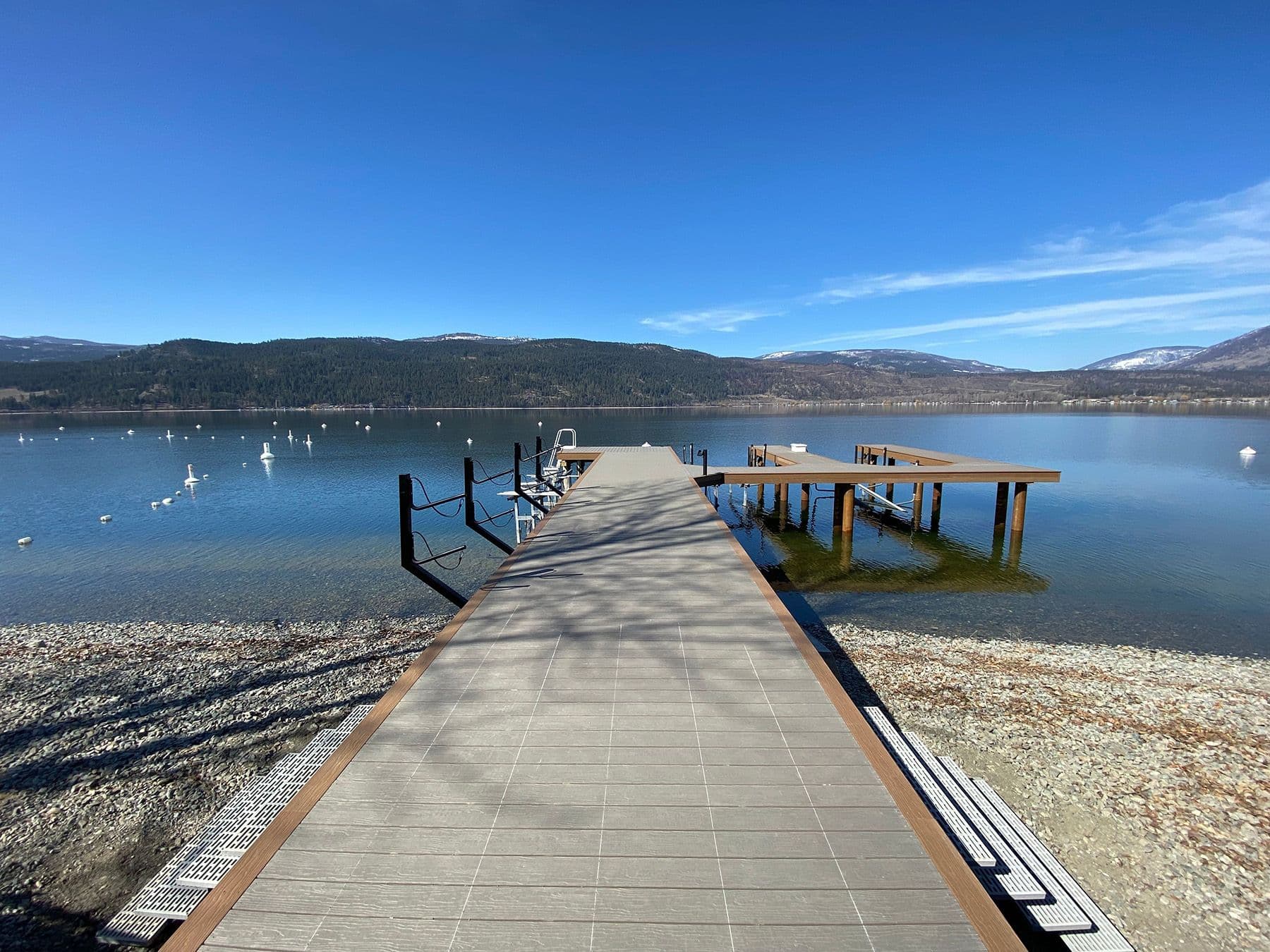 Newly installed composite dock with enhanced boat lifts and modern decking on Okanagan Lake, built for long-lasting waterfront performance and ease of use.
